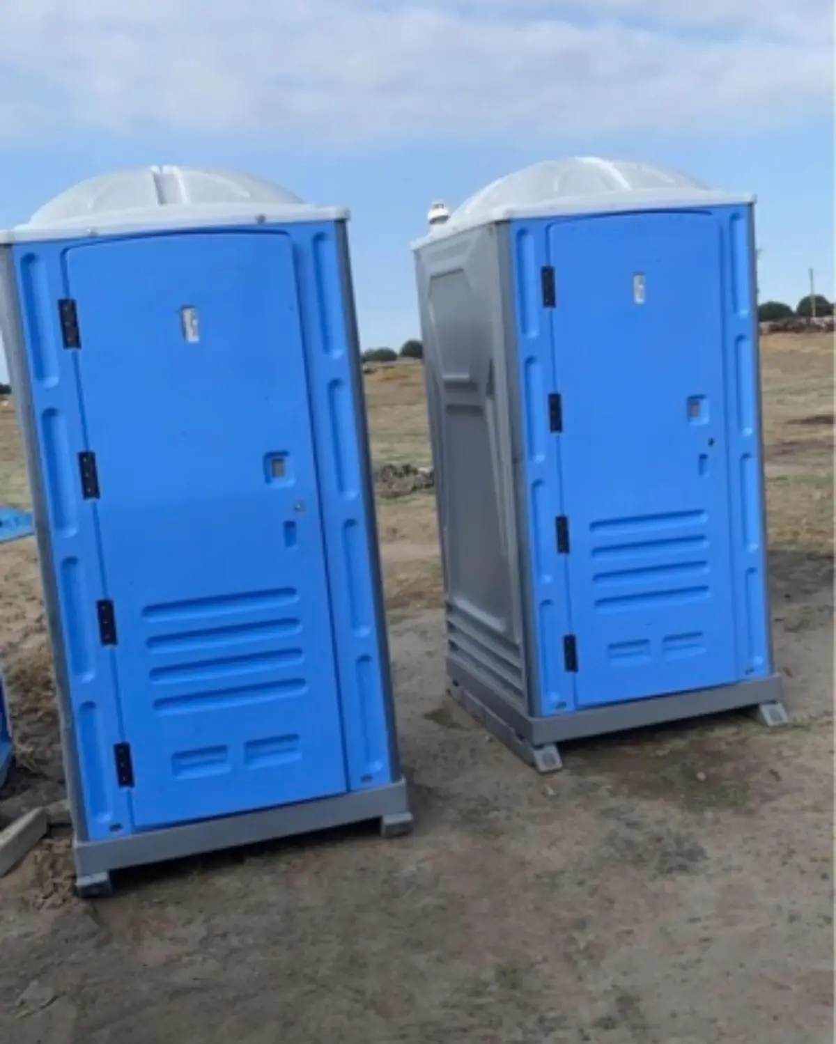 Two standard porta potties on a jobsite
